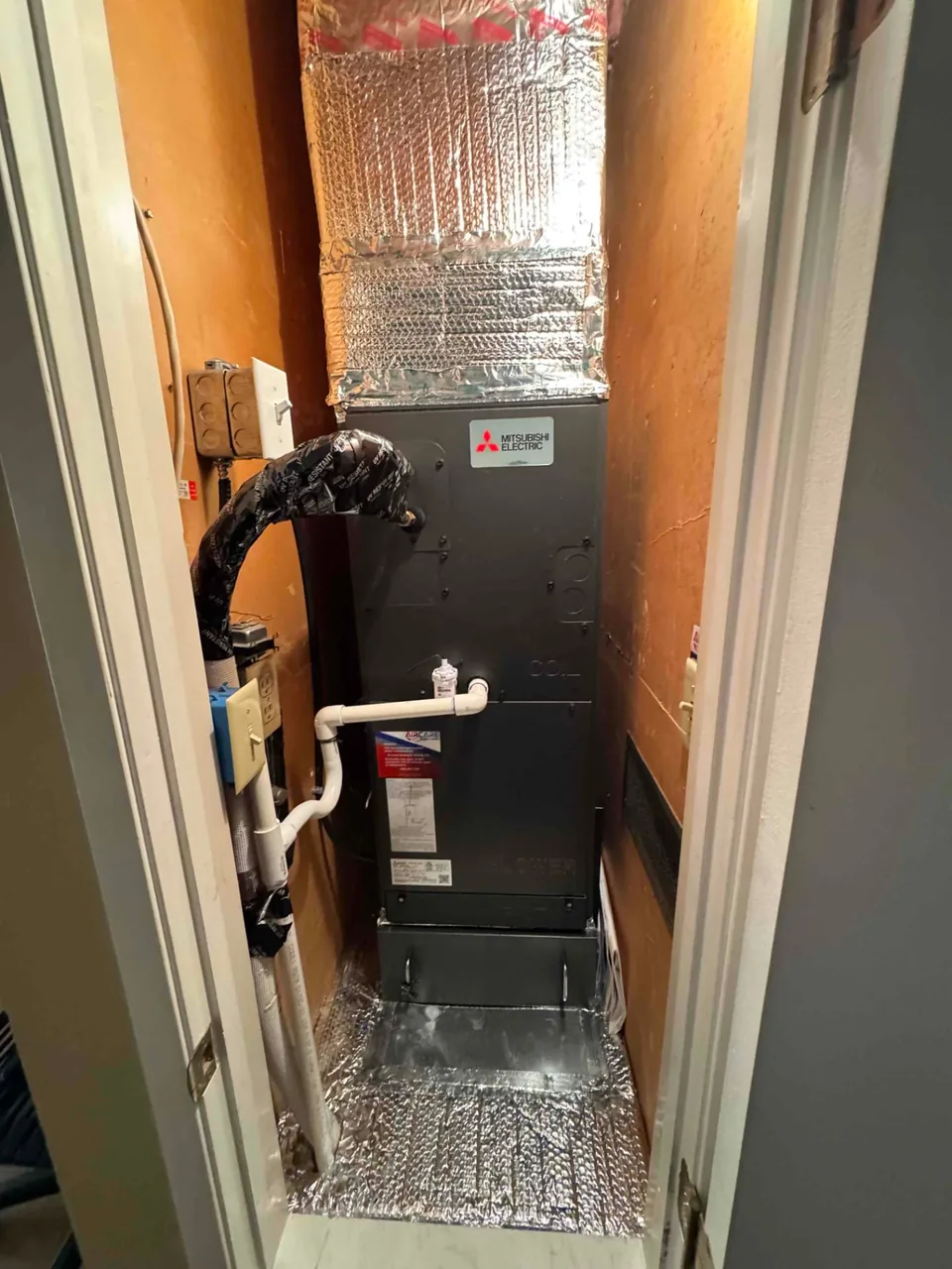 Mitsubishi ducted heat pump indoor equipment in a utility closet in San Jose