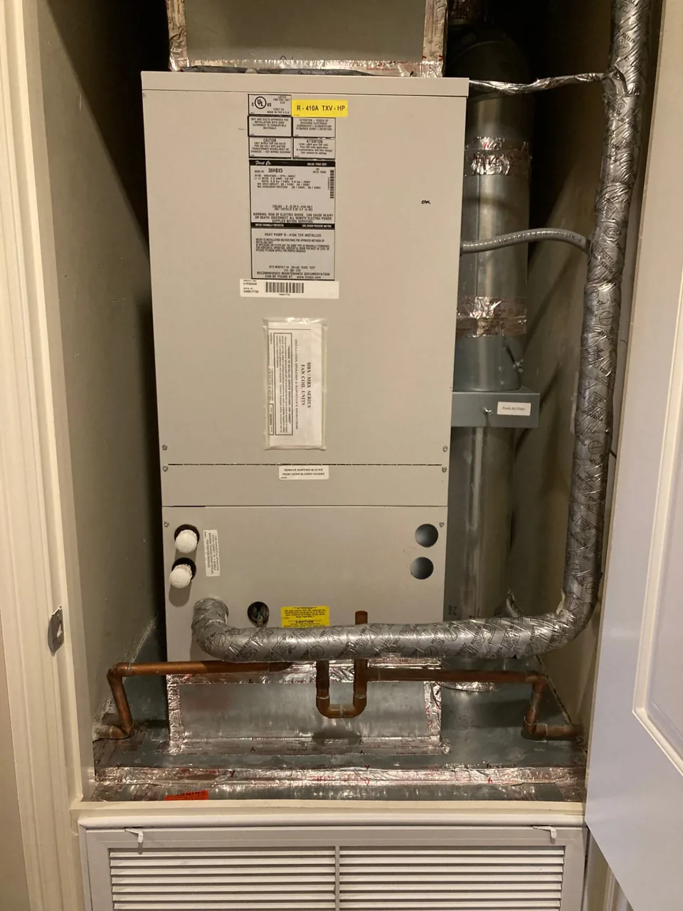Indoor heat pump equipment and connected ductwork in a condo utility closet