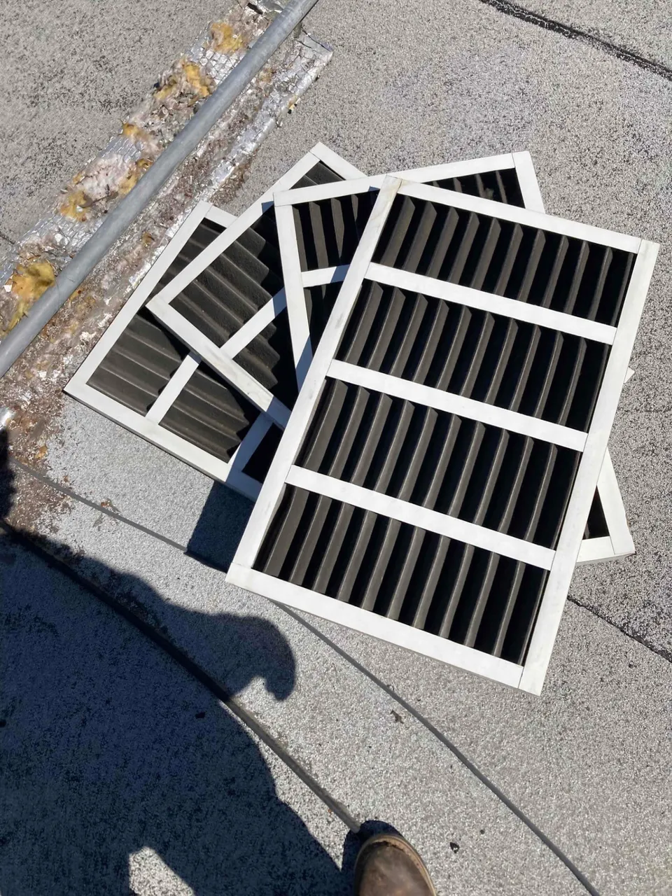 Dirty air filters removed from rooftop package units at a commercial building in Santa Clara CA 95050