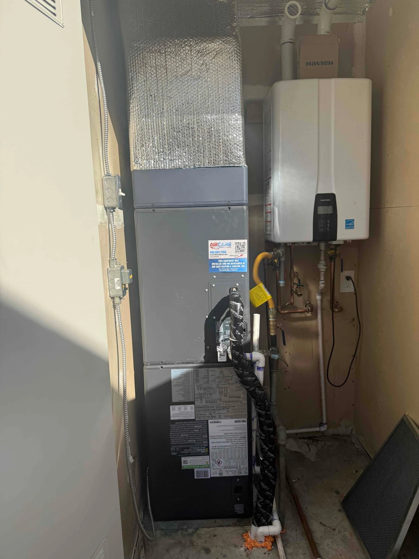 Gray Bryant indoor HVAC cabinet with insulated ductwork in a utility closet