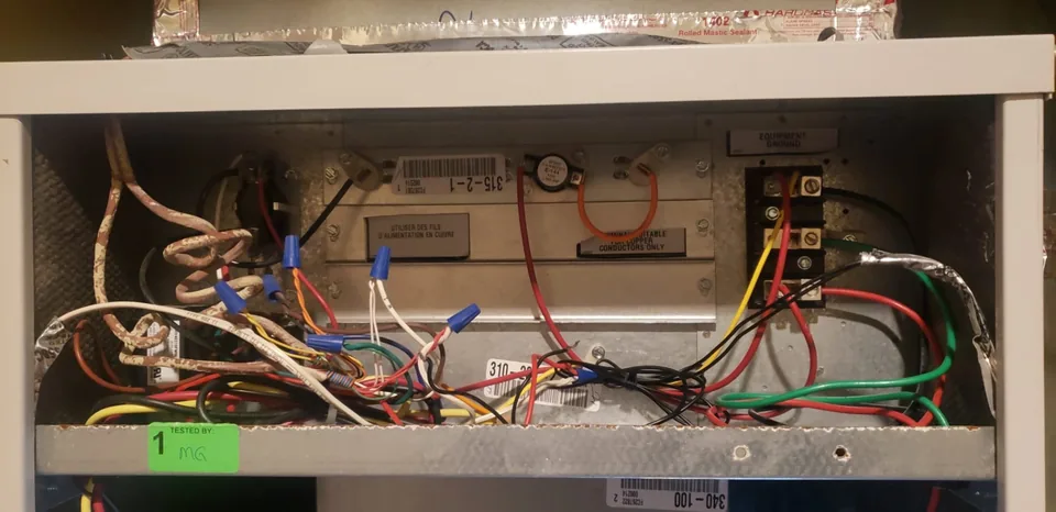 Open indoor heat pump equipment showing wiring and controls