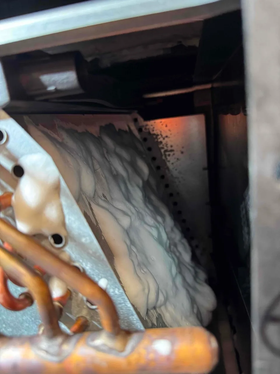 Cleaning solution applied to the Mitsubishi ducted heat pump indoor coil during maintenance
