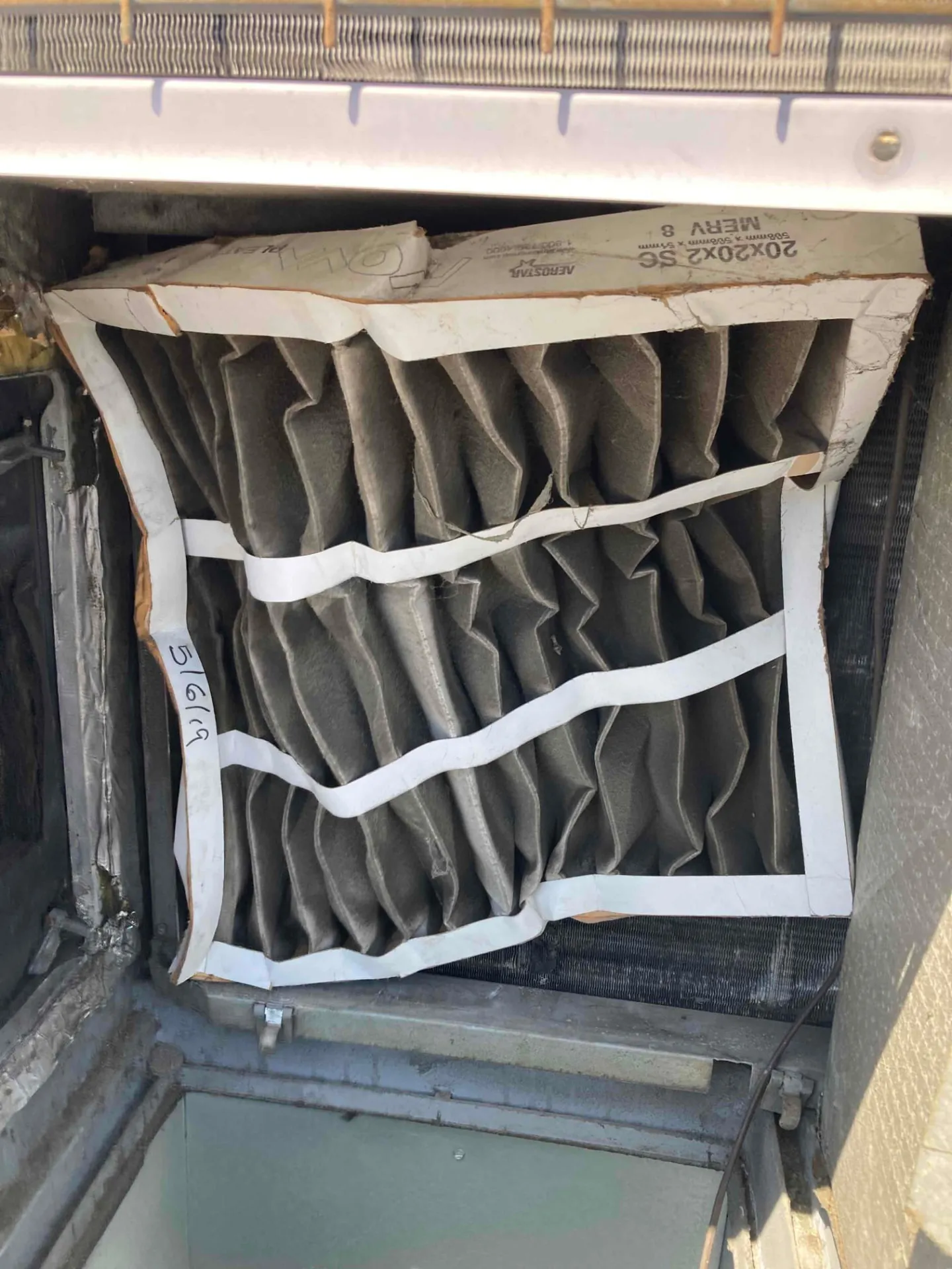 Extremely dirty pleated air filter found inside a rooftop package unit at a commercial building in Santa Clara CA 95050