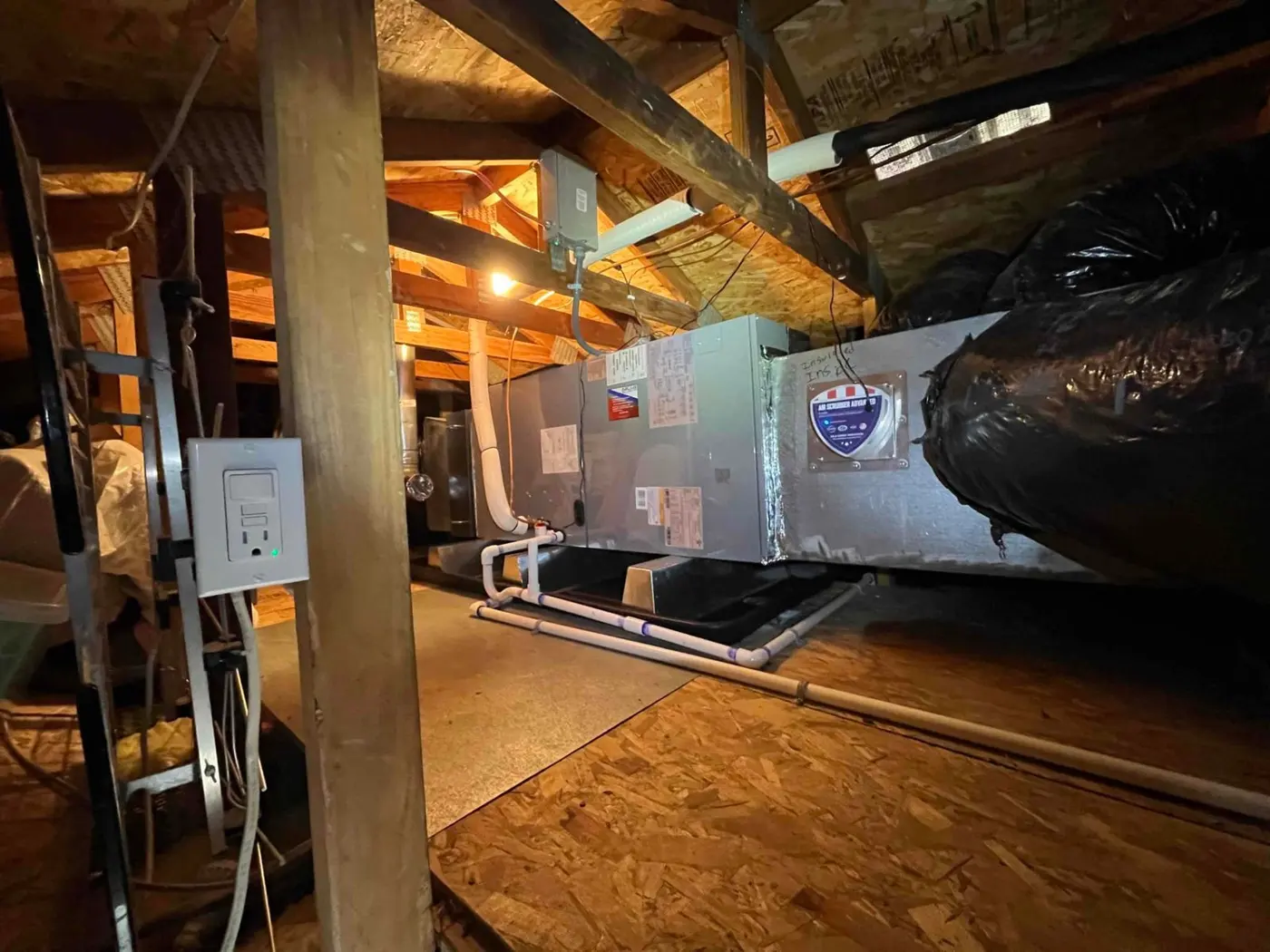 New air handler installed horizontally in the attic with insulated ductwork and an Air Scrubber indoor air quality device attached
