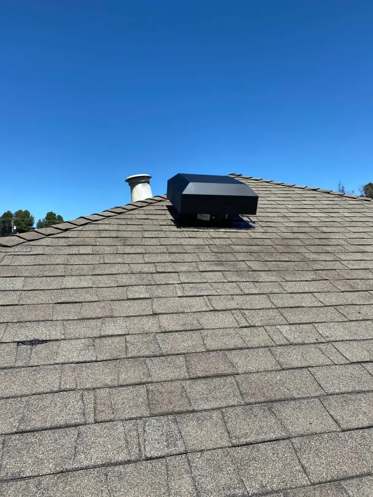 Black attic fan roof vent housing installed on a shingled roof in Santa Clara, CA 95051