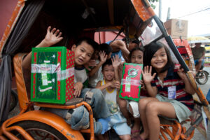 Children receiving Christmas gifts