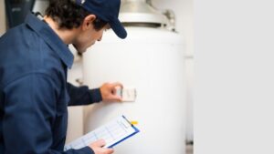 Technician inspecting a water heater.